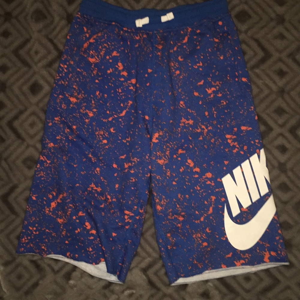 Blue Nike shorts with little orange spots